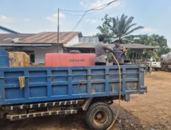 Peduli Kenyamanan Warga, Dua Personel Polsek Nanga Tayap Turun Langsung Siram Jalan Berdebu